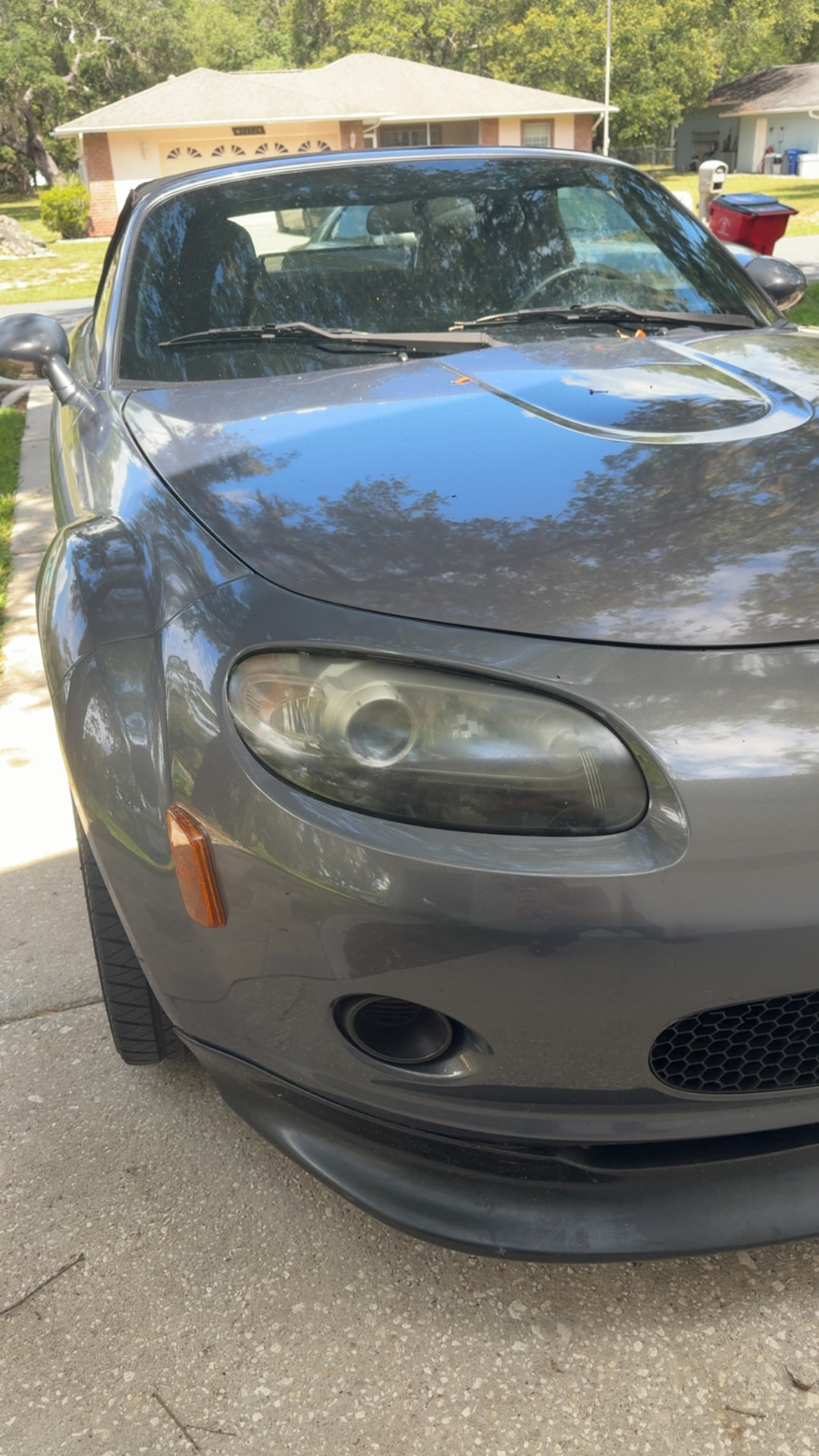 Mazda MX-5 Miata headlight with foggy oxidation before restoration in Citrus County FL