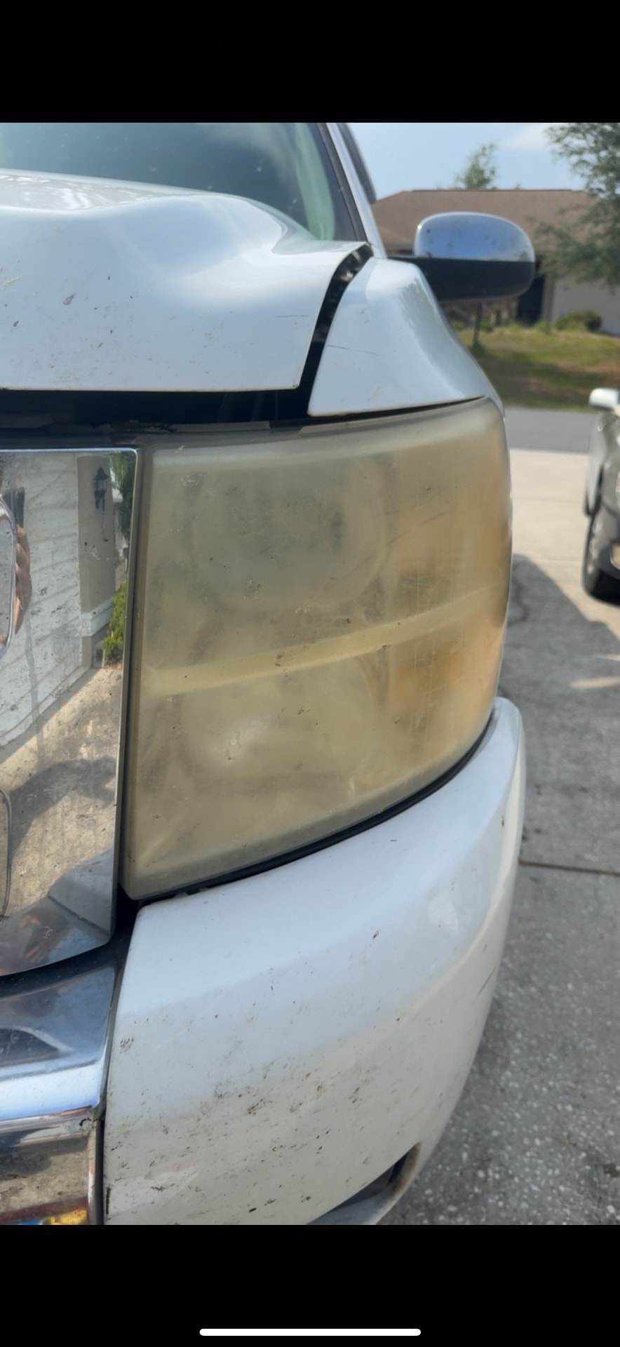 Chevrolet Silverado headlight with severe yellowing and oxidation before restoration in Citrus County FL