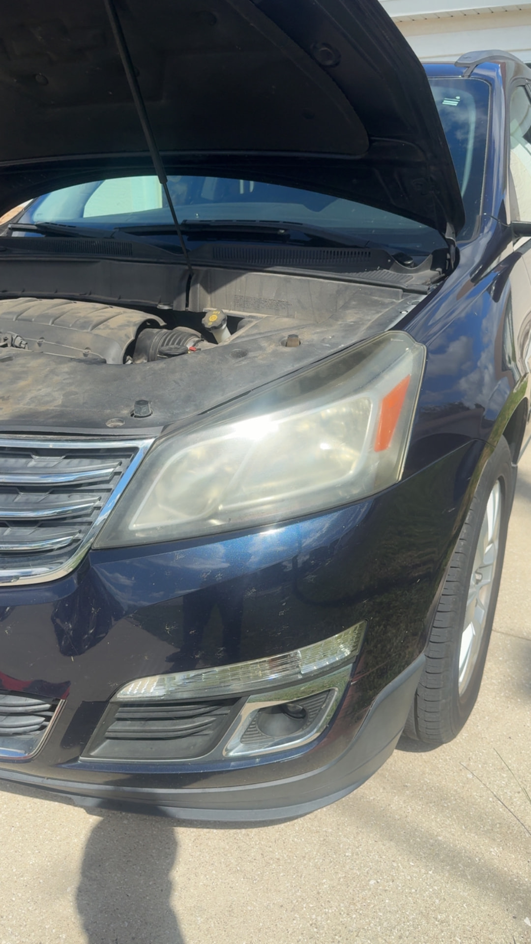 Chevrolet Traverse headlight with heavy yellowing and oxidation before restoration in Citrus County FL