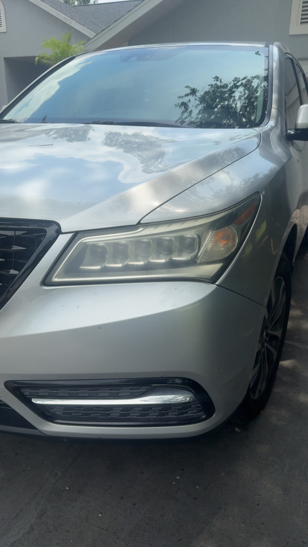 Acura MDX headlight with hazy yellowed lens before restoration in Citrus County FL
