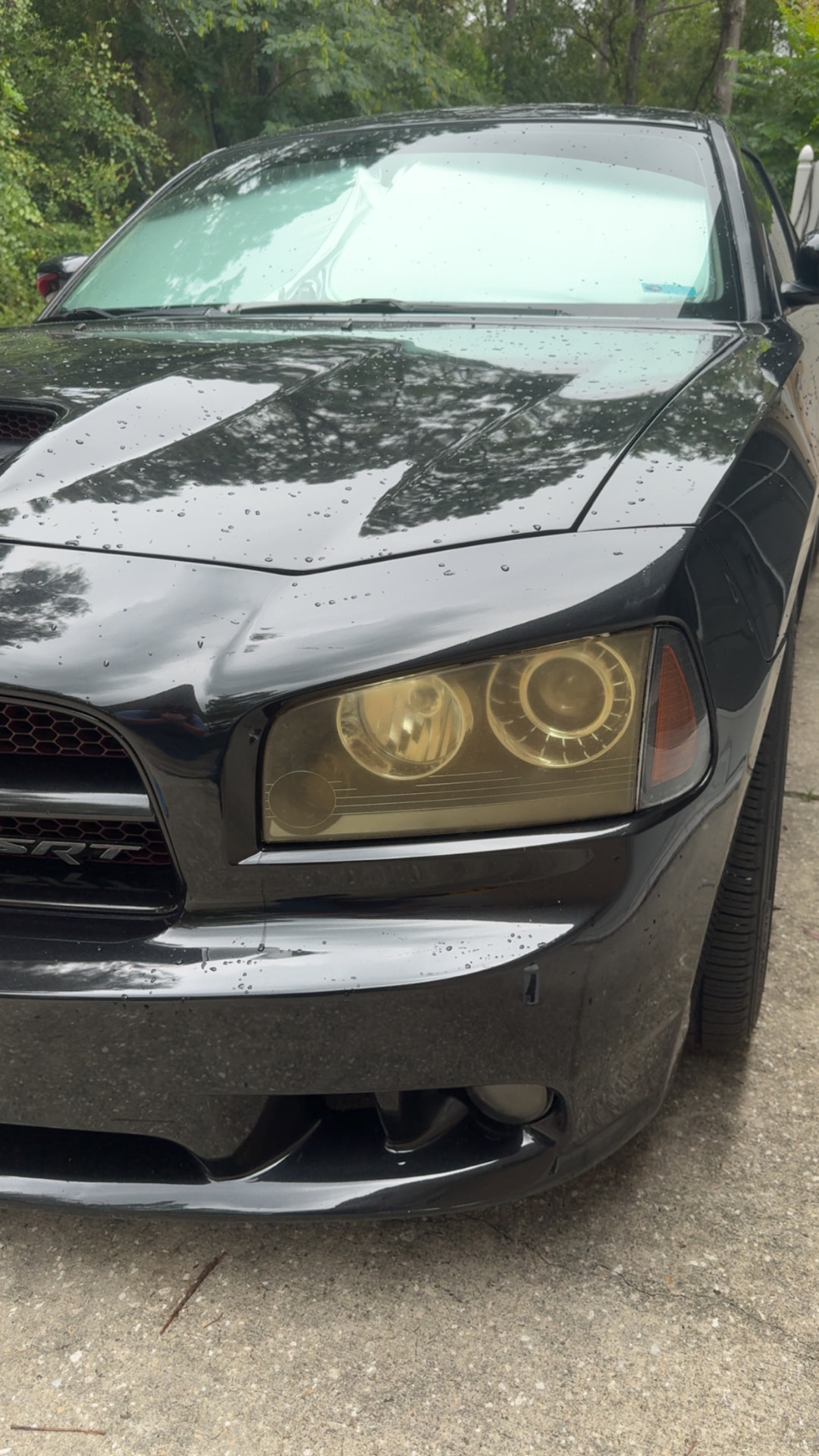 Dodge Charger SRT headlight with heavy amber yellowing before restoration in Citrus County FL